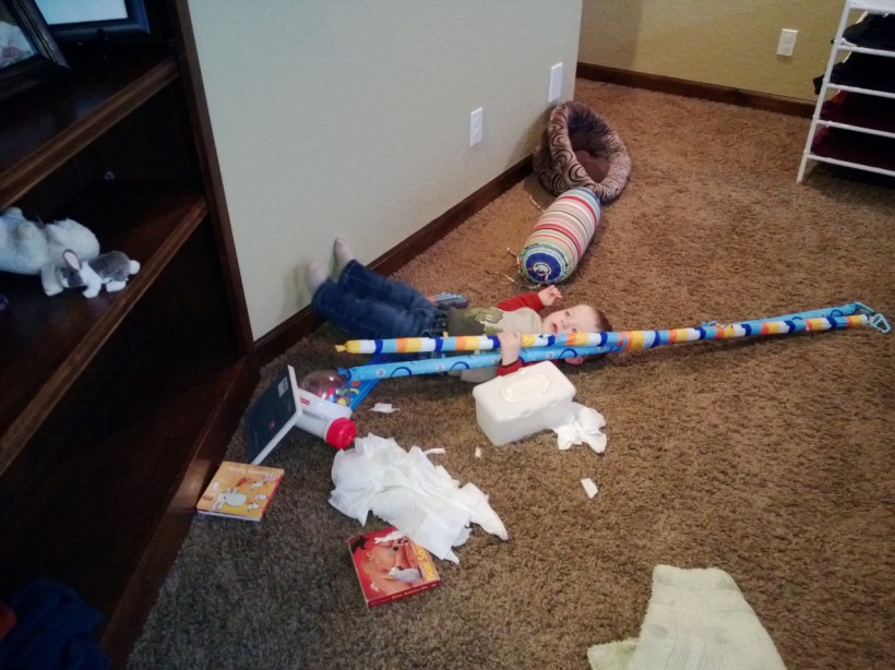 A box of wipes, CG, old baby gym support rods, a bunch of books, and one cute little boy!