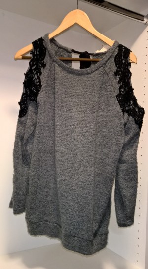 I love this sweater - it is so fun to wear!  It has a tie neck in the back and it's open in the back